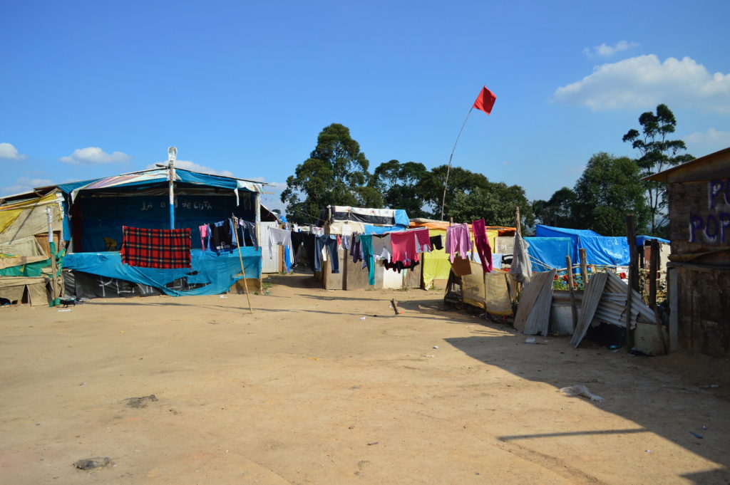 The New Palestine housing movement encampment, pictured in 2015, dry and hot during a severe drought.